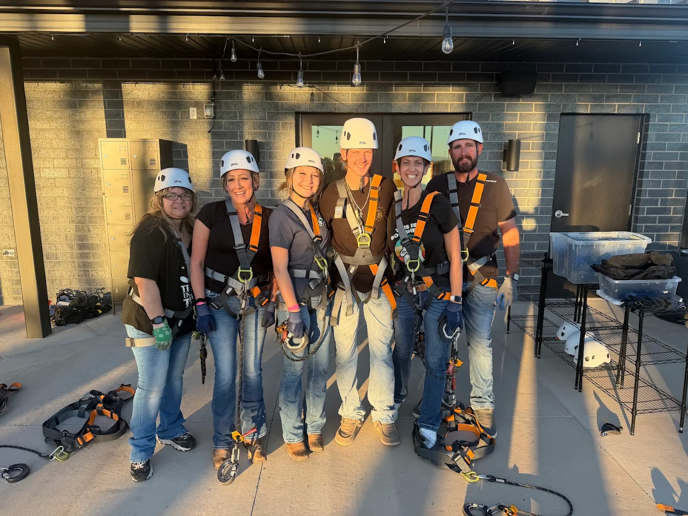 friends-group-ropes-course-adventure-park-hurricane-utah-night-out Group of friends geared up for ropes course adventure near St George Utah enjoying group activity at adventure park in Hurricane