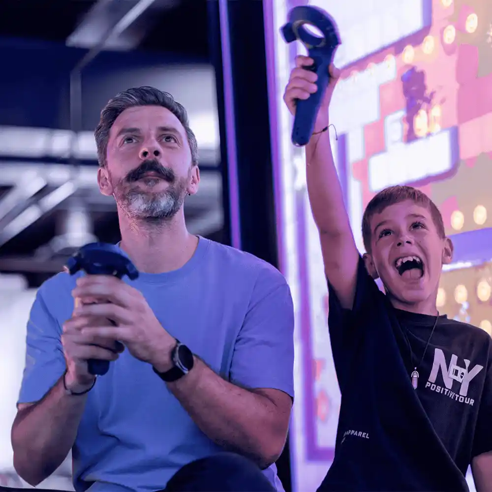 Dad and son playing QBIX interactive VR game room in Hurricane Utah with immersive multiplayer experience
