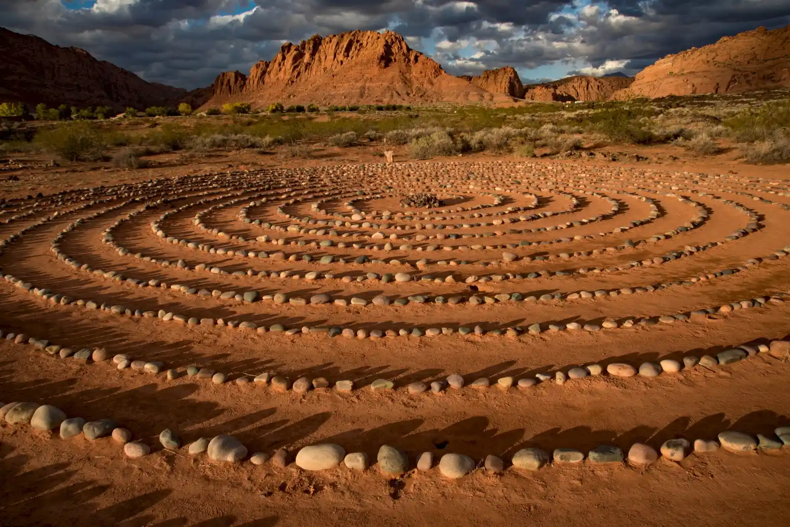 st-george-utah-desert-labyrinth-red-rock-southern-utah-landscape Stone labyrinth in red desert landscape Snow Canyon St George Utah with mountains and scenic Southern Utah terrain