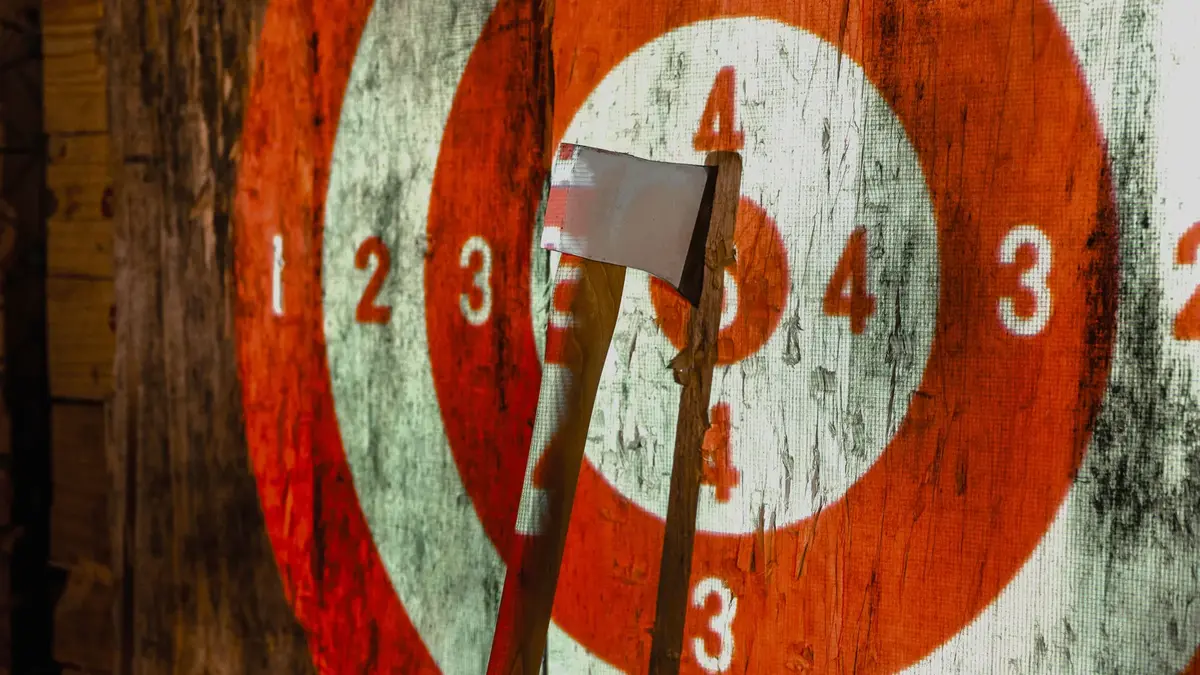 Close up of axe hitting bullseye on wooden target at Wiked Timber Axe Throwing in Hurricane Utah showing precision throws and indoor activity near Zion