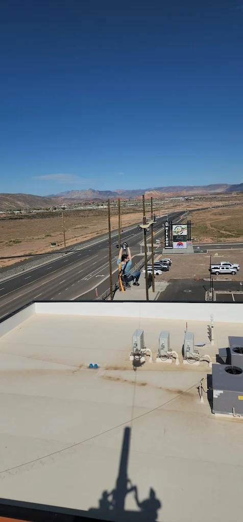 Person getting ready to launch from zipline platform in Hurricane Utah near Zion with desert views and guided setup
